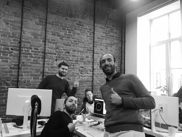 Members of the Cindicator team at their desks